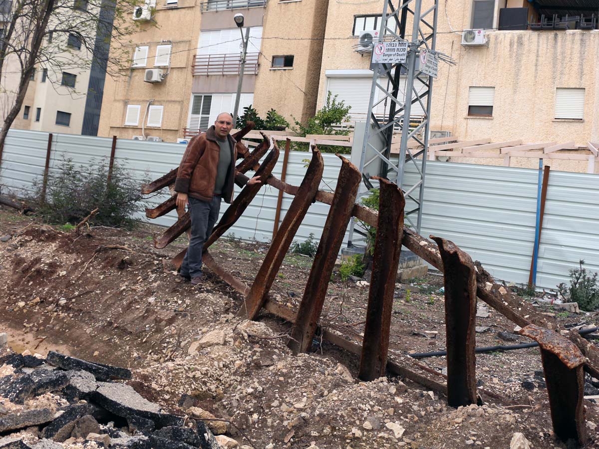 מנכ"ל החברה כלכלית עפולה תומר חדד עם פסי הרכבת ההיסטורים שאותרו בחפירות מתחת לעפר הרב